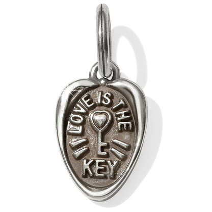 Brighton heart charm with raised Love Is The Key inscription and central key motif on a white background