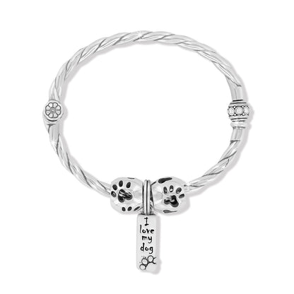 Brighton silver-plated twisted bangle bracelet with enamel paw print charms and I love my dog tag on a white background