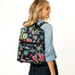 Brighton backpack with black graphic print featuring love, hearts, globes, and colorful doodle illustrations throughout