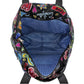 Close-up of Brighton handbag interior showing blue heart-print lining and colorful graphic print exterior with zippered pocket