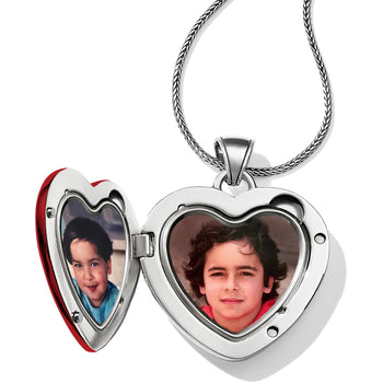 Brighton silver-plated heart locket necklace shown open with two photos inside and woven chain on a white background
