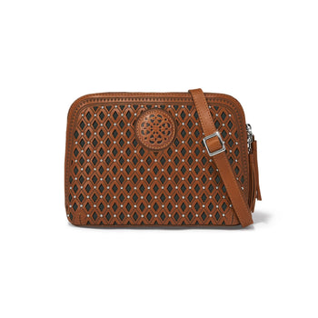 Brighton crossbody handbag in brown leather with diamond cutout pattern, studs, medallion, and tassel zipper on a white background
