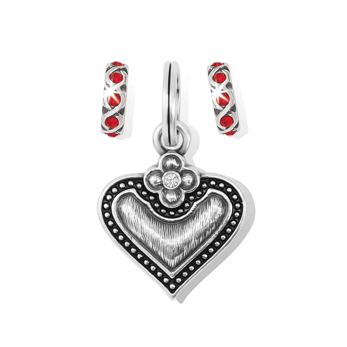 Brighton heart charm with silver-plated beaded border, flower accent, and two red crystal spacer charms on a white background