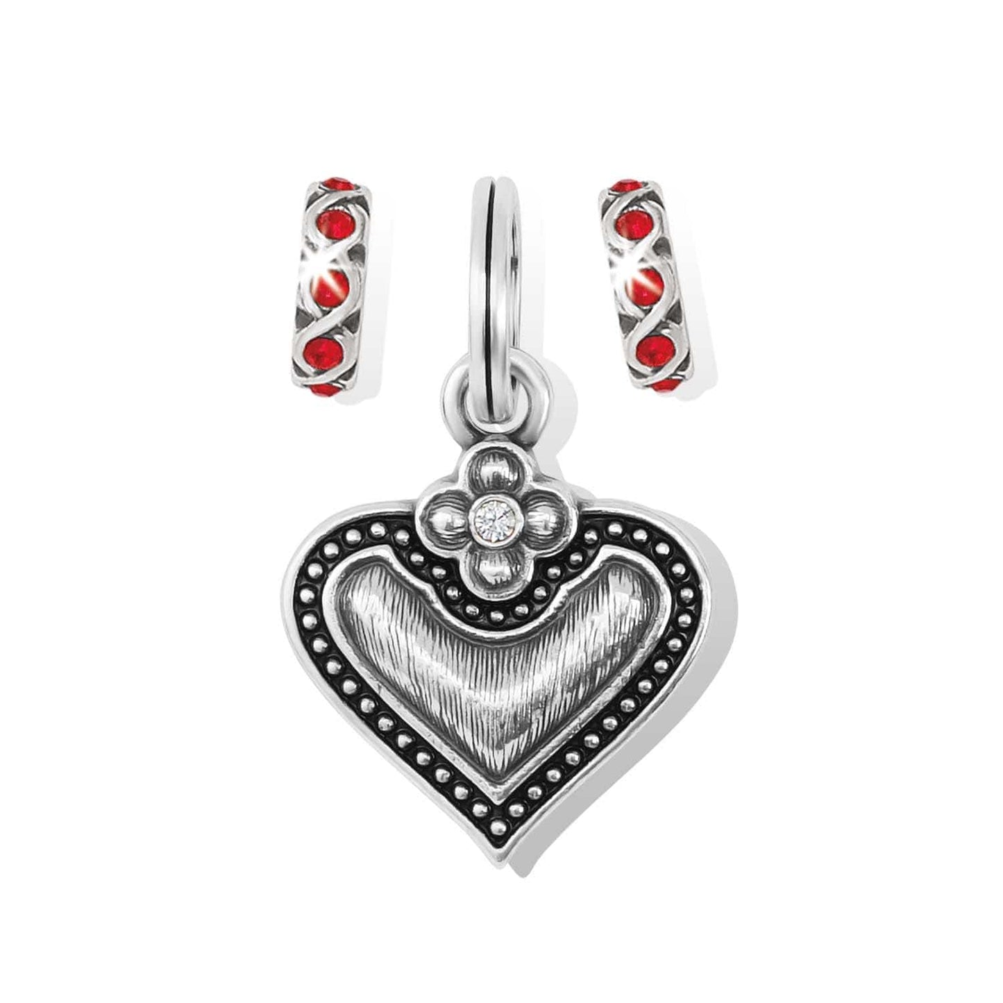 Brighton heart charm with silver-plated beaded border, flower accent, and two red crystal spacer charms on a white background