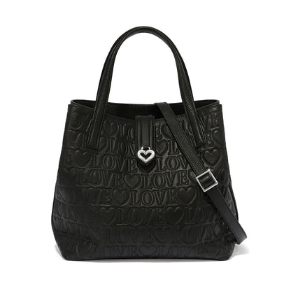 Brighton handbag in black leather with embossed love and heart pattern, silver-tone heart clasp on a white background