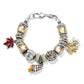 Brighton charm bracelet with silver-plated beads, amber crystals, enamel maple leaves, and acorn charms on a white background