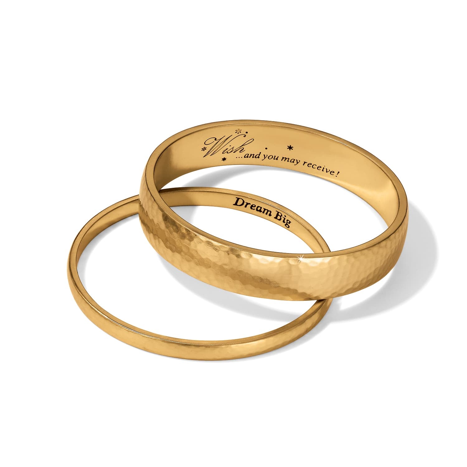 Brighton gold bangle bracelets with hammered texture and engraved Wish and Dream Big inscriptions on a white background