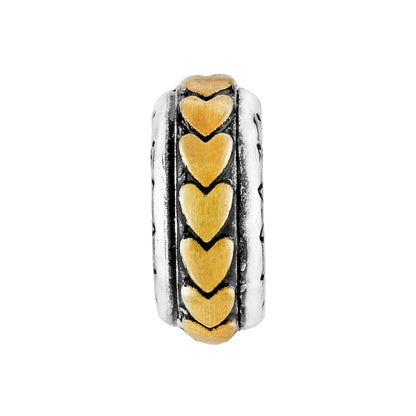 Brighton spacer charm with gold-tone heart motifs and silver-tone textured edges on a white background