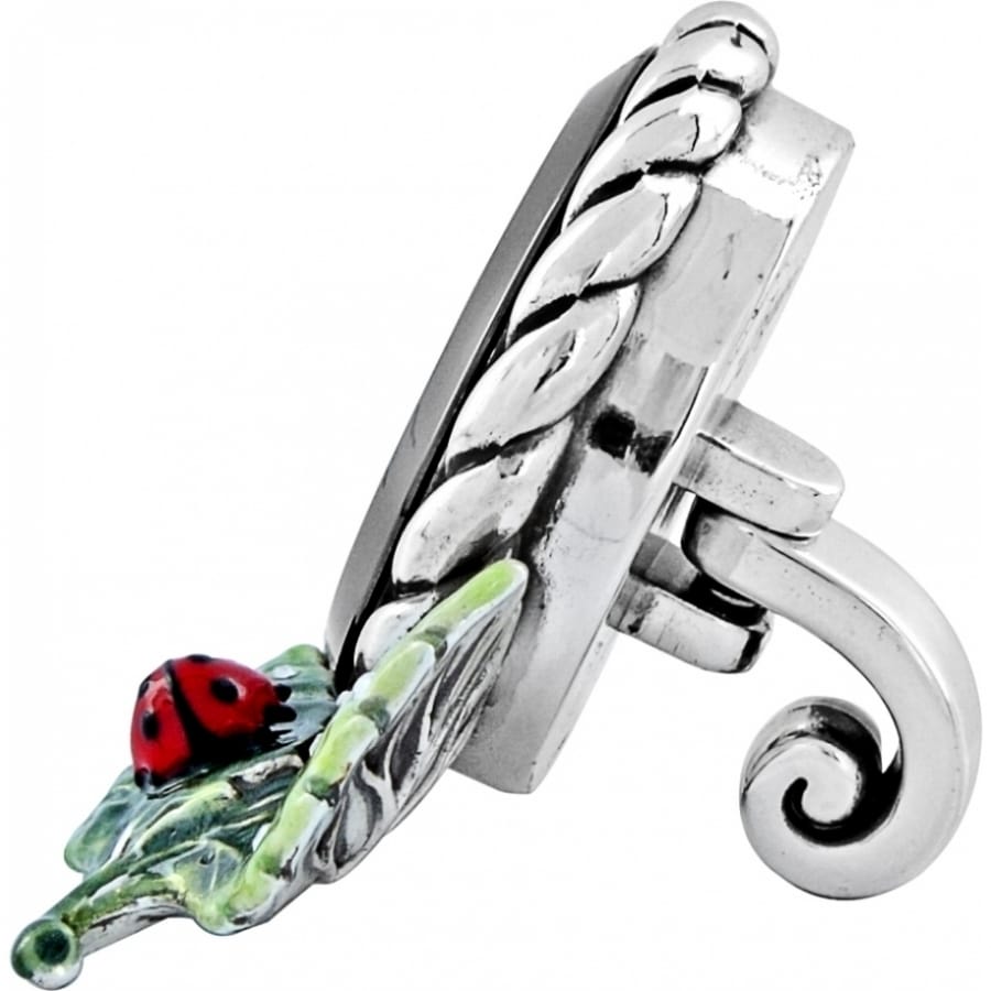 Brighton ring side view with braided silver-tone band, enamel leaf, and red ladybug detail on a white background