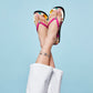 Model wearing Brighton pink rubber flip-flop sandals with floral print footbed and crystal accents at the toe post