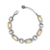 Medici Two Tone Link Bracelet a silver and gold-tone link bracelet rests against a white background. There is a decorative toggle clasp on one end.