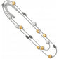 Brighton layered necklace with hammered silver-plated and brushed gold discs and scroll station beads on a white background