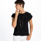 Model wearing a long Brighton necklace with brushed gold and hammered silver-plated disc stations paired with matching bracelet