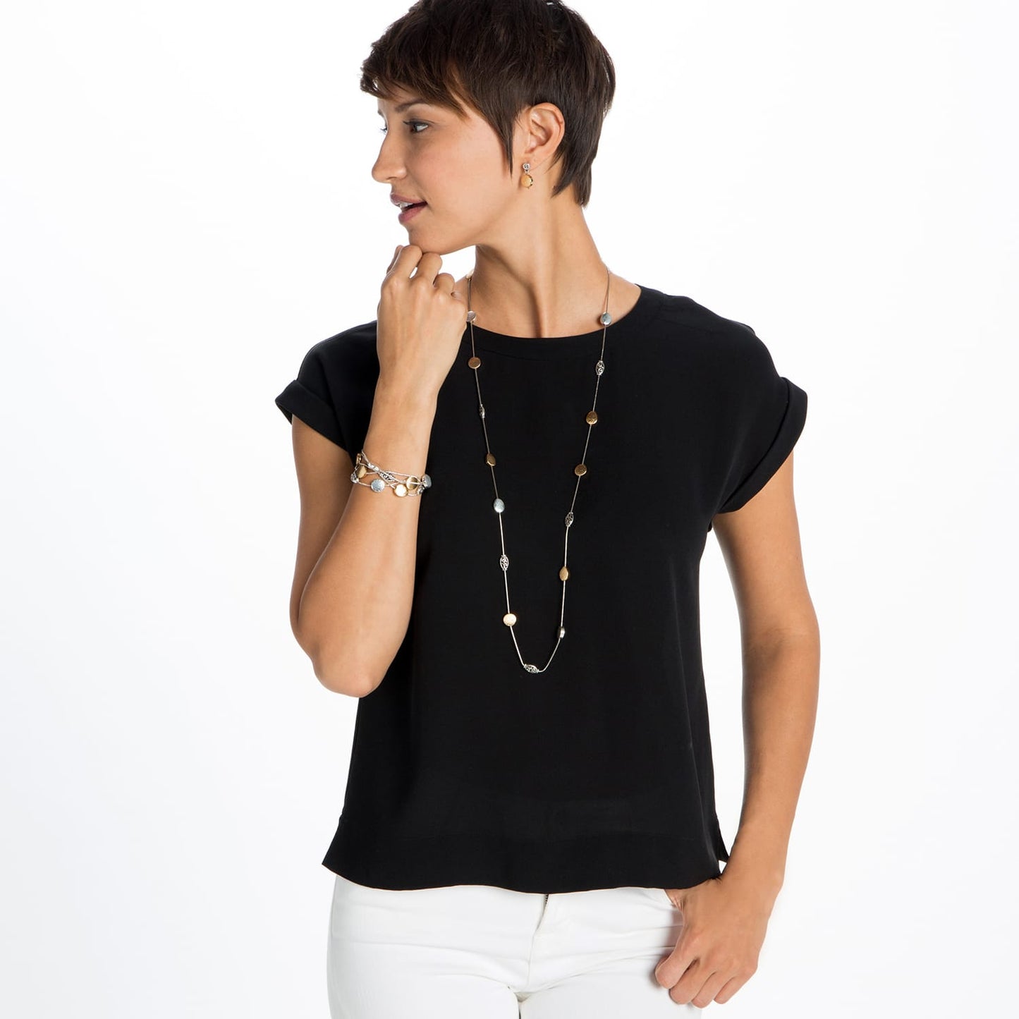 Model wearing a long Brighton necklace with brushed gold and hammered silver-plated disc stations paired with matching bracelet