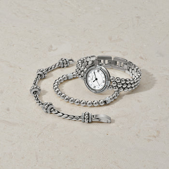 Brighton silver-plated watch with crystal-accented bezel styled with beaded bracelets featuring crystal stations on neutral background