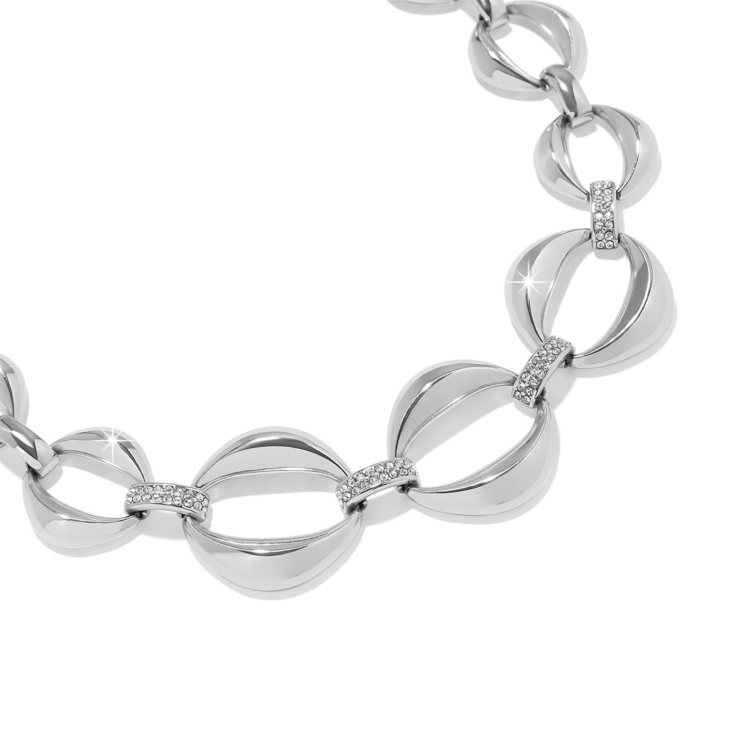 Brighton silver-plated link bracelet with curved oval links and crystal pavé connectors on a white background