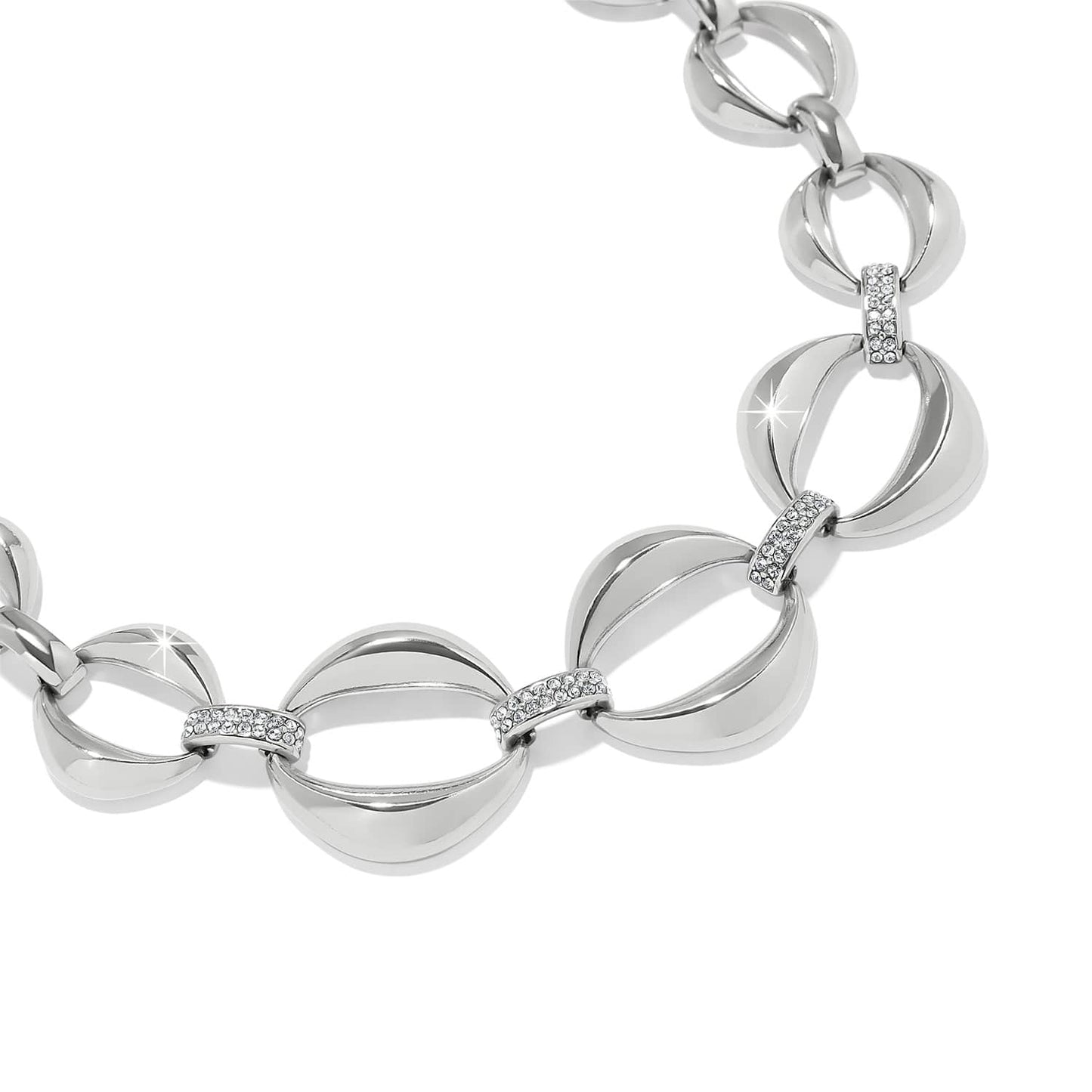 Brighton silver-plated link bracelet with curved oval links and crystal pavé connectors on a white background