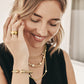 Model wearing a Brighton brushed gold plated ring with hammered band and coordinating Brighton accessories