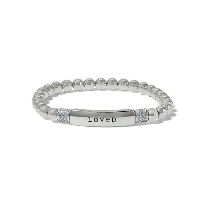 Brighton beaded stretch bracelet with silver-plated beads, LOVED engraved bar, and crystal accents on a white background
