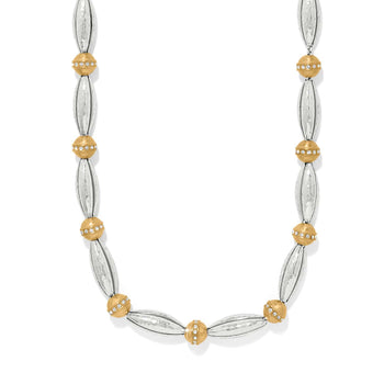 Brighton necklace with silver-tone hammered oval beads and gold-tone round beads accented with crystals on a white background