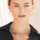Model wearing Brighton gold-plated layered necklaces with crystal stations paired with matching gold-plated hoop earrings