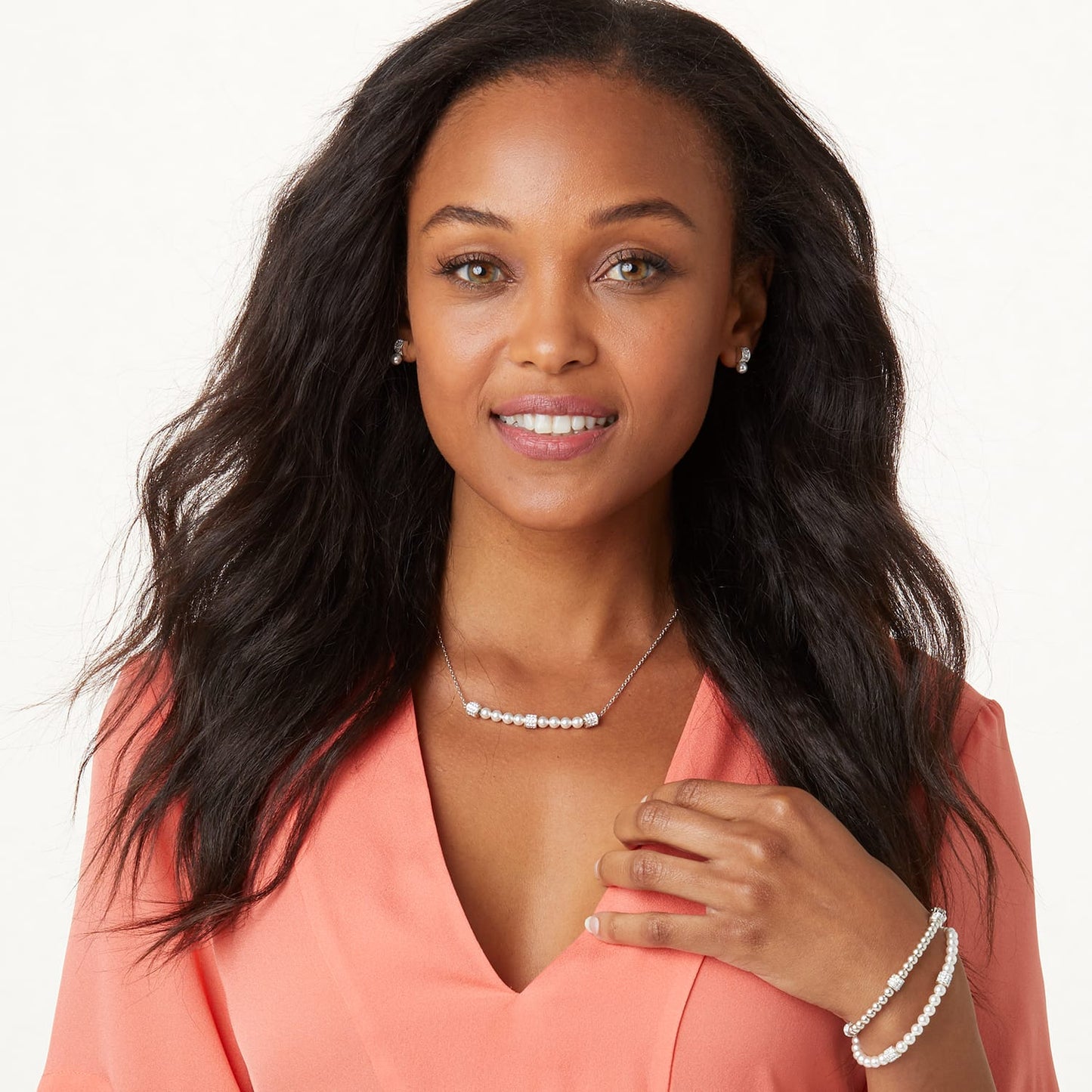 Model wearing a Brighton silver-plated pearl necklace with crystal accents paired with matching pearl earrings and bracelet