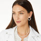 Model wearing Brighton pearl hoop earrings with crystal accents paired with a matching pearl and crystal necklace
