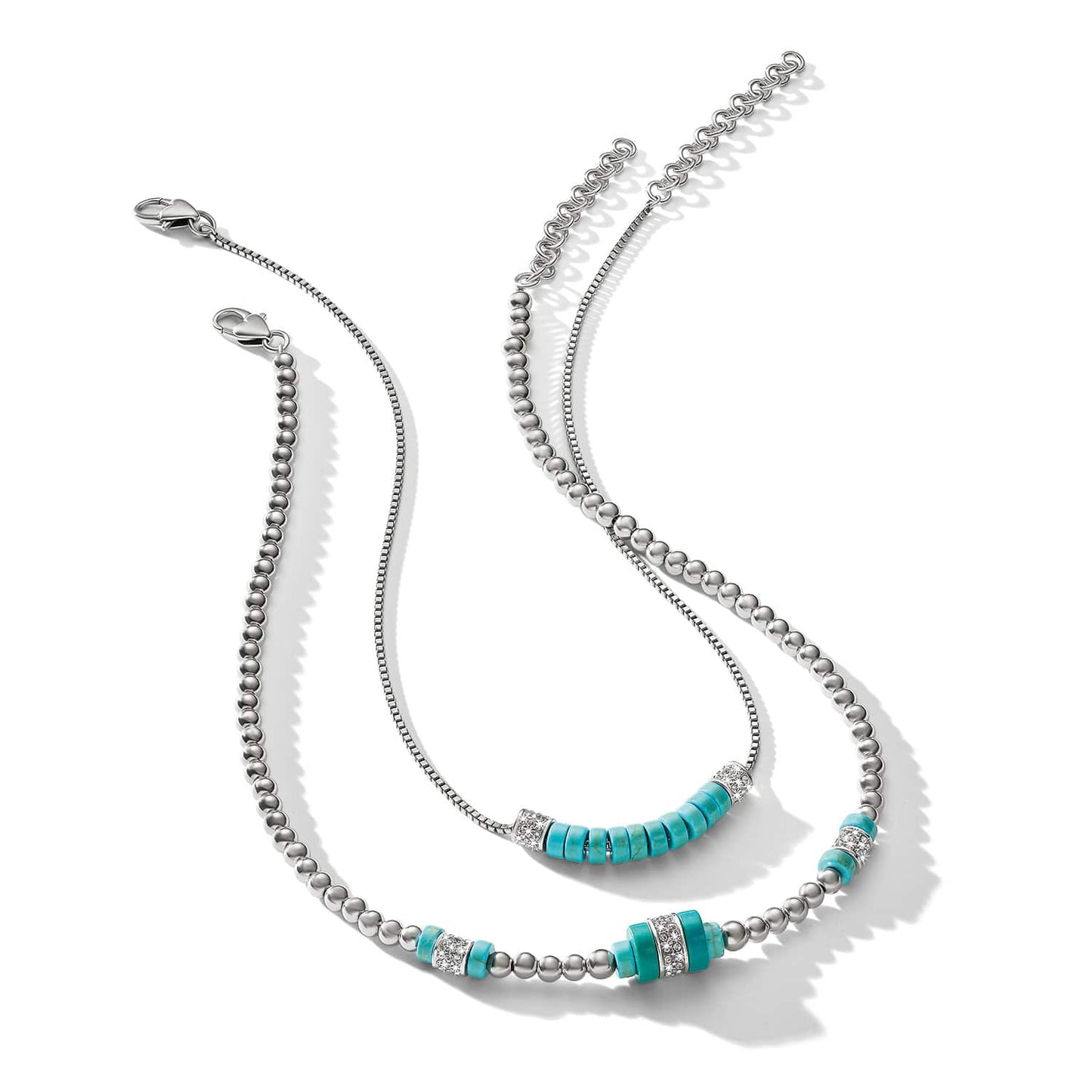 Brighton layered necklaces with silver-plated beads, turquoise stones, and crystal accents on a white background