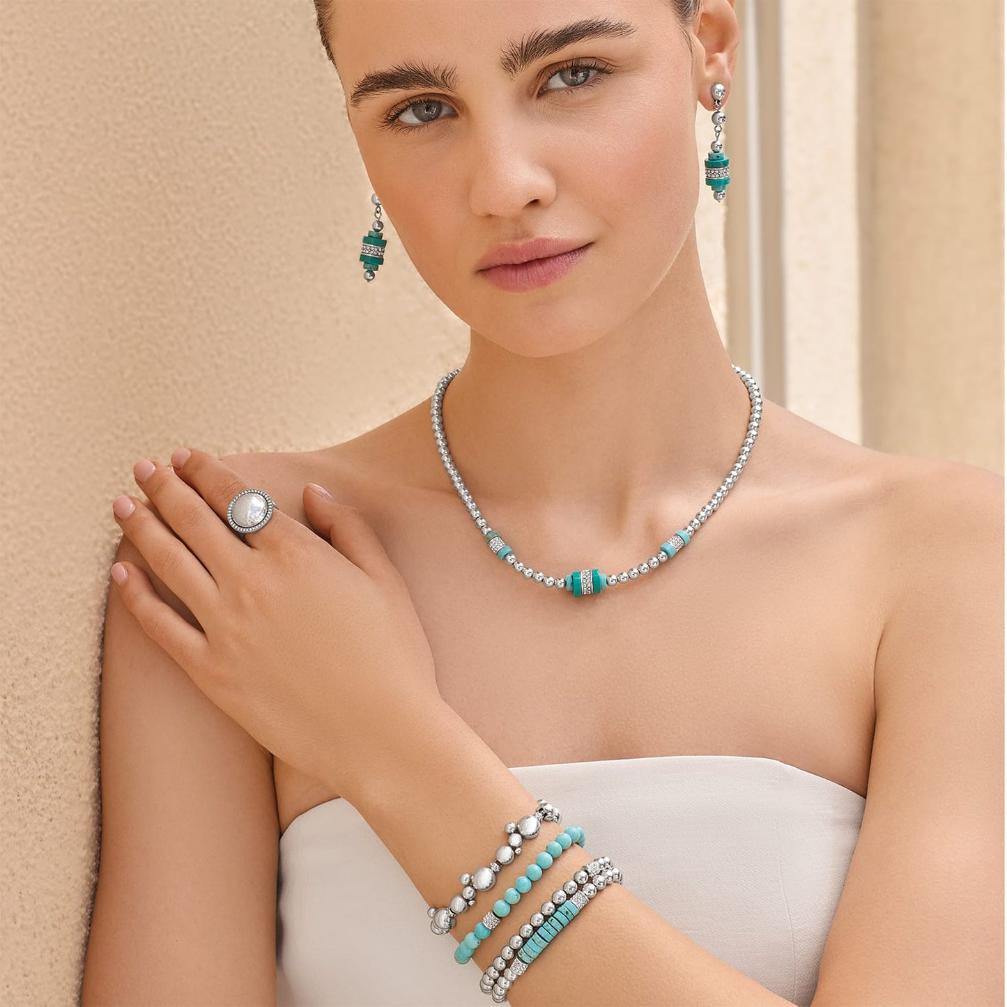 Model wearing a Brighton silver-plated beaded necklace with turquoise accents and coordinating Brighton accessories