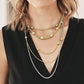 Model wearing layered Brighton two-tone necklaces with crystal-accented stations in silver and gold chain styles