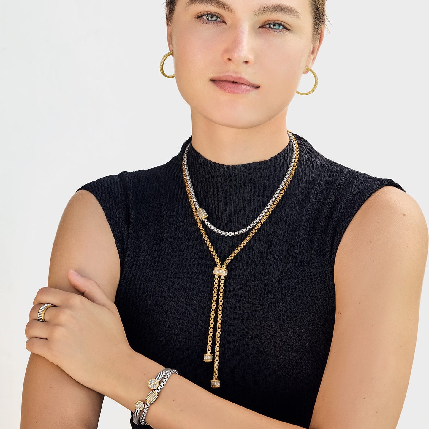 Model wearing a Brighton two-tone lariat necklace with crystal accents and coordinating Brighton accessories