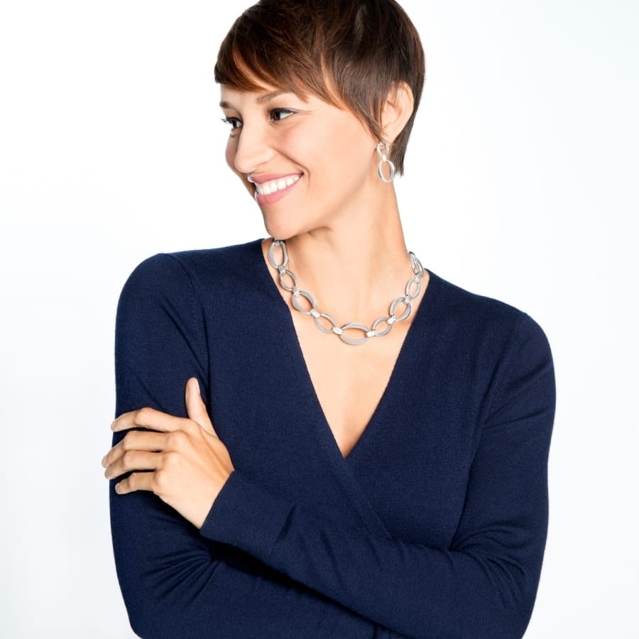Model wearing a Brighton silver-plated oval link chain necklace paired with matching silver-plated oval drop earrings