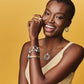 Model wearing a Brighton two-tone circle pendant necklace with coordinating Brighton accessories including bracelets, earrings, and rings