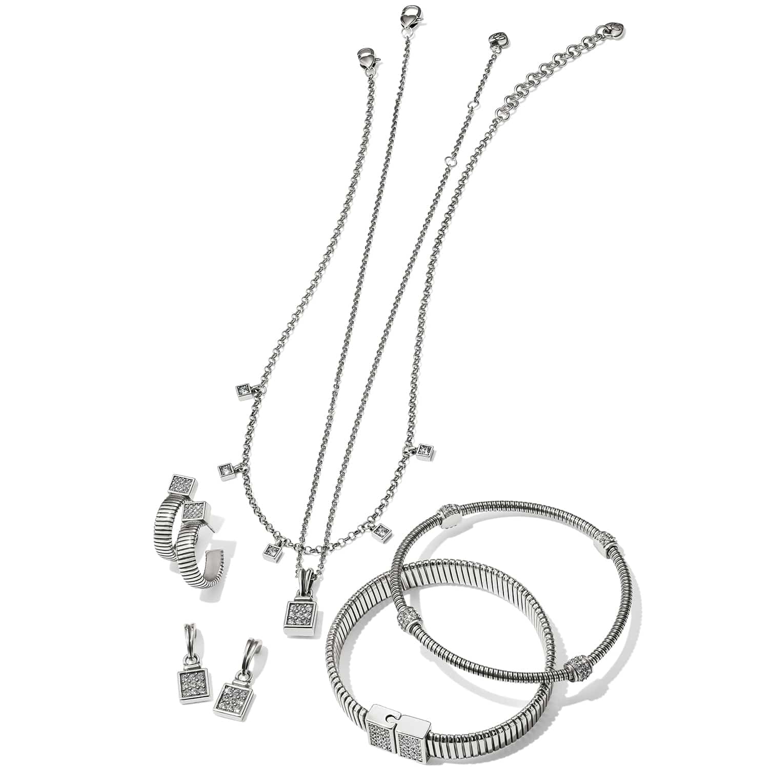 Brighton silver-plated jewelry set styled with matching necklaces, hoop earrings, charm drops, and ribbed bangles with crystal accents