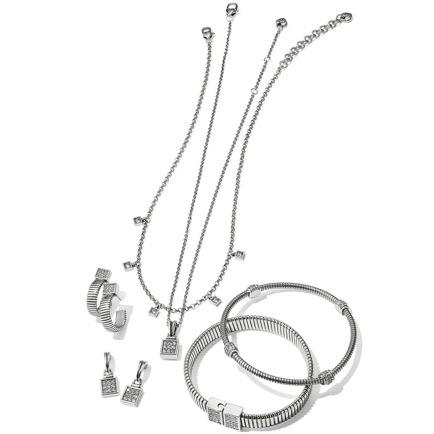 Brighton silver-plated jewelry set styled with matching necklaces, hoop earrings, charm drops, and ribbed bangles with crystal accents
