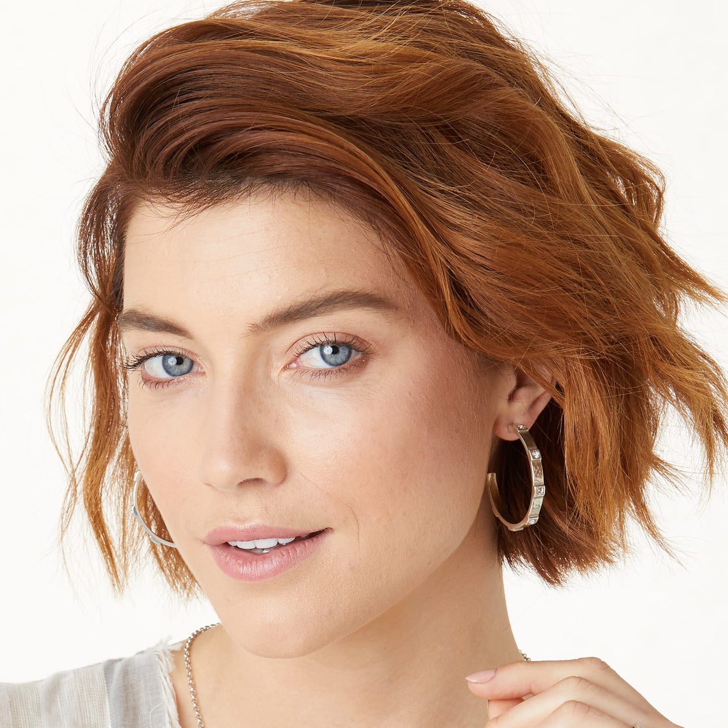Model wearing a Brighton silver-plated hoop earring with crystal accents and textured metal detailing