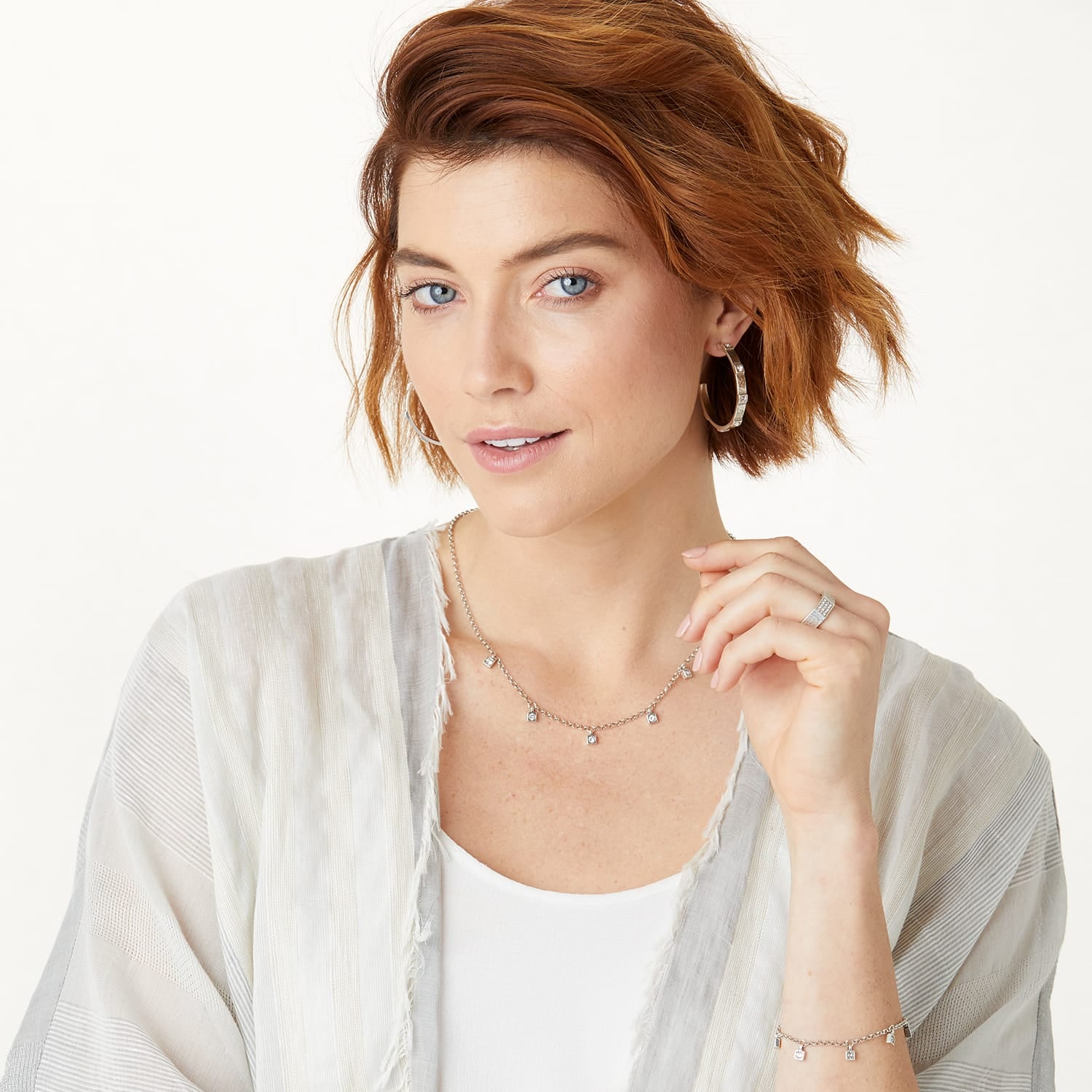 Model wearing a Brighton silver-plated necklace with crystal drop accents and coordinating Brighton accessories