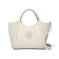 Brighton handbag in cream leather with woven side panels, dual handles, and circular medallion accent on a white background
