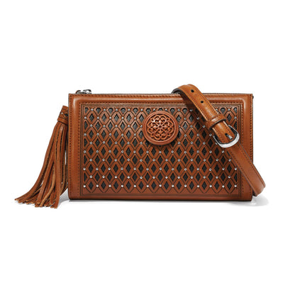 Brighton brown leather crossbody handbag with diamond studded pattern, medallion accent, tassel, and adjustable strap on a white background