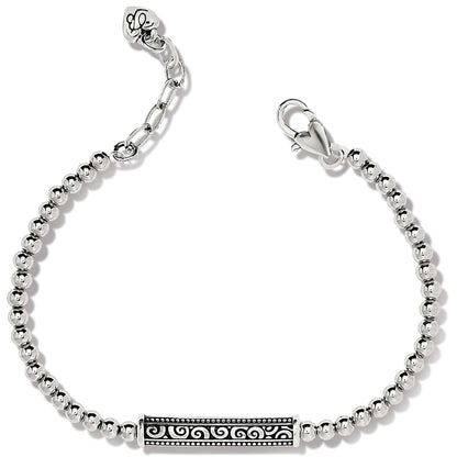 Brighton beaded bracelet with silver-plated round beads and engraved scroll bar station with lobster clasp on a white background