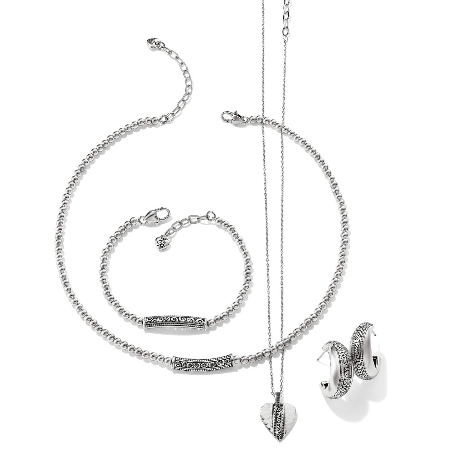 Brighton silver-plated jewelry set styled with beaded necklace, bracelet, heart pendant necklace, and scroll-detailed hoop earrings