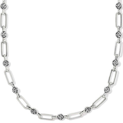 Brighton silver-plated chain necklace with elongated links and round scroll-engraved beaded stations on a white background