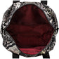 Close-up of Brighton handbag interior view showing burgundy lining, zippered pocket, and snake-print exterior trim