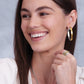 Model wearing Brighton two-tone hoop earrings in silver and gold, paired with a coordinating Brighton two-tone ring