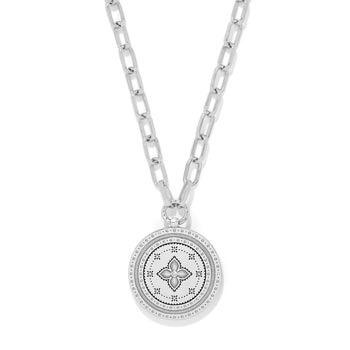 Brighton pendant necklace with silver-tone medallion featuring engraved floral motif and crystal center on a white background