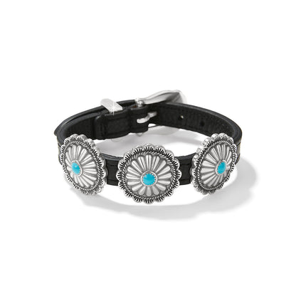 Brighton bracelet with black leather band, three silver-plated concho medallions with turquoise centers, on a white background
