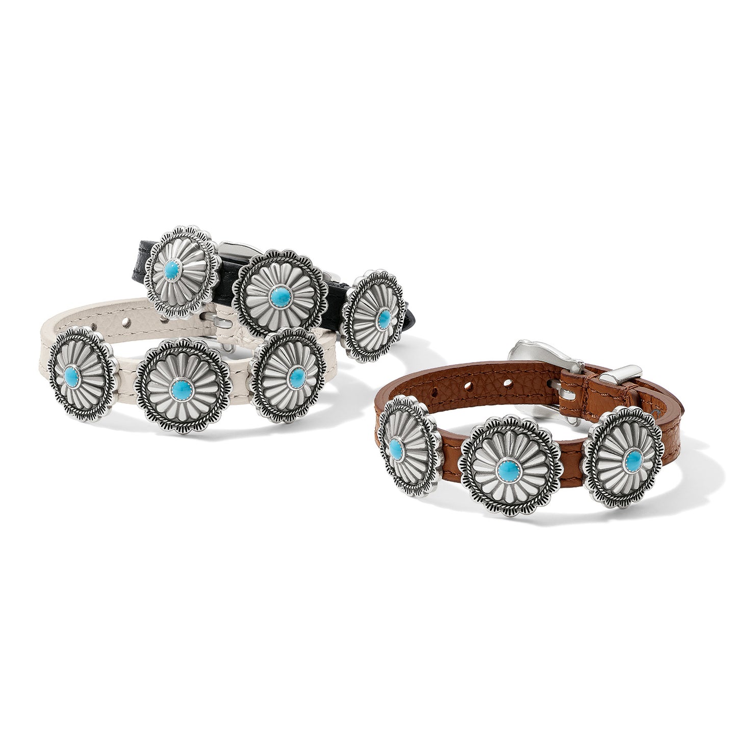 Brighton leather bracelets in black, white, and brown with silver-plated concho stations and turquoise centers on a white background