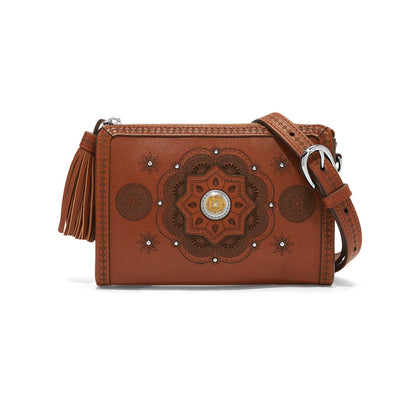 Brighton crossbody handbag in brown leather with embossed medallion design, tassel, and silver-tone buckle on a white background