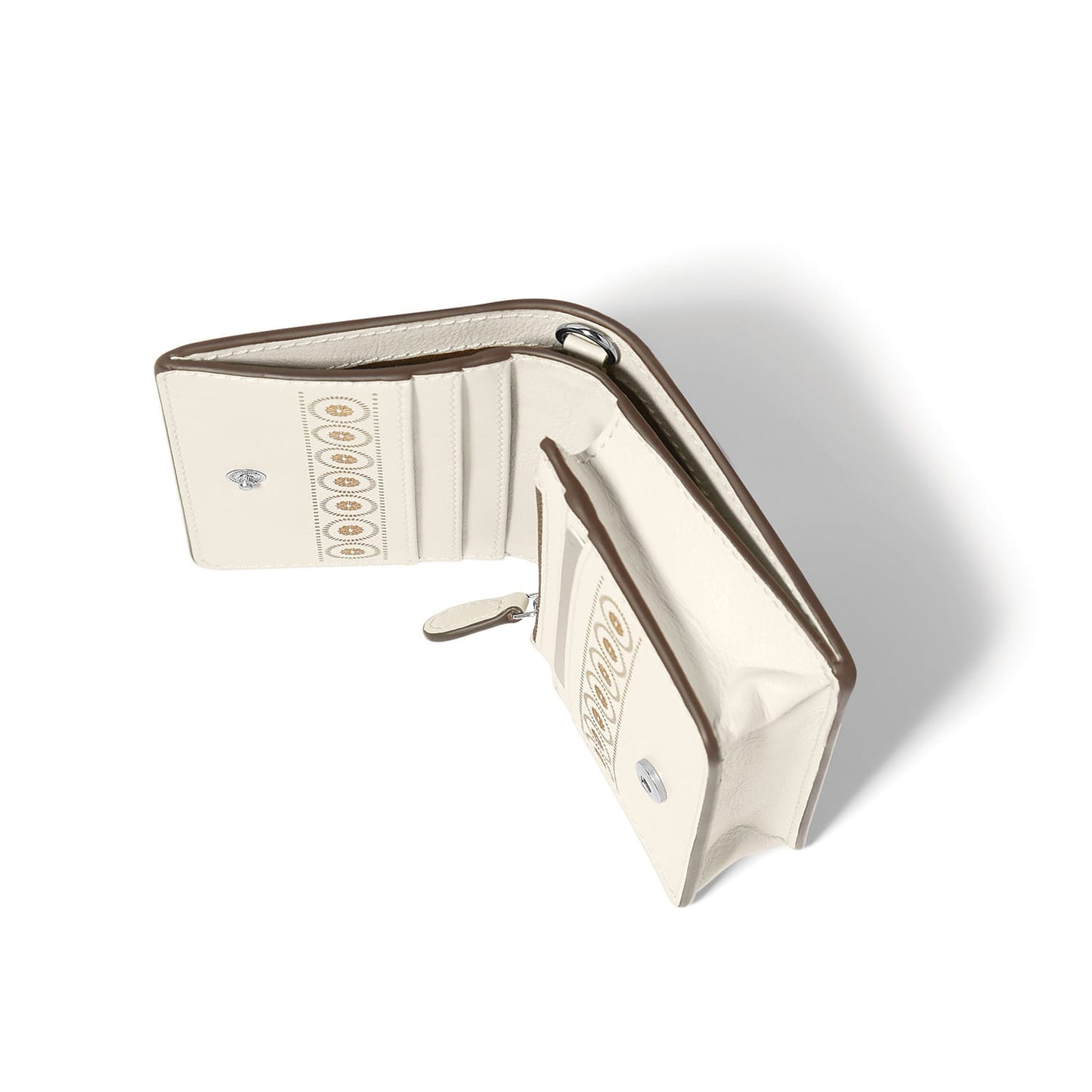 Brighton wallet shown open with cream interior, card slots, zip coin pocket, and decorative medallion print on a white background