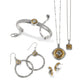 Brighton two-tone jewelry set styled with a bangle bracelet, hoop earrings, and pendant necklaces on white background